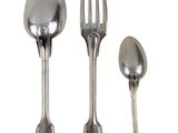 three spoons and a fork sitting next to each other