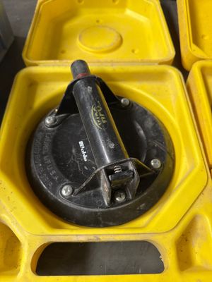 a yellow container with a black handle and a yellow container with a black handle