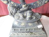 a statue of a woman holding a bird on a table