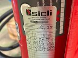 a red fire extinguisor with a sticker on it