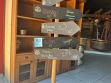 many signs on a pole in front of a store