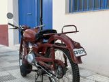 a red motorcycle parked on the side of the street