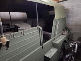a green truck that is parked in a garage