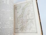 an open book with a map in it on a table
