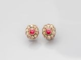 a pair of ruby and diamond earrings