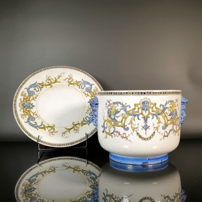 a cup and saucer sitting on a table next to a plate