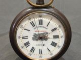 a small clock with roman numerals on the face