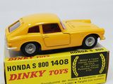 yellow toy car sitting on top of a boxed box on a white surface