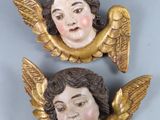 pair of antique angel heads on a blue background