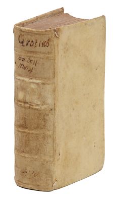 an old book sitting on top of a white surface