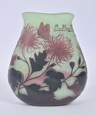 a small vase with flowers and a butterfly on it