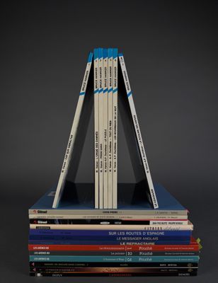 books stacked on top of each other on a black surface