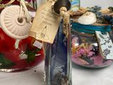 a glass bottle filled with different items on a table