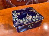 a small blue box sitting on a wooden table