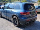 the rear end of a blue mercedes suv parked in a parking lot