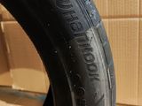 a close up of a tire on a cardboard box with a cardboard box in the background