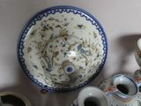 many different types of vases and bowls on the table