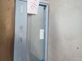 a metal box with a sign on it next to a wall