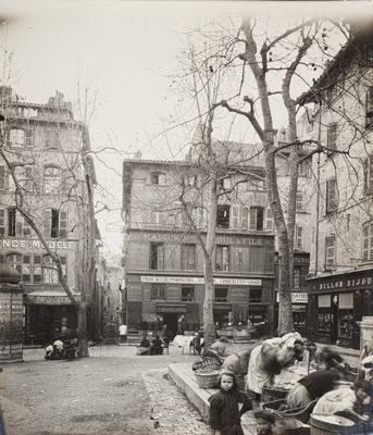 many people sitting on a bench in the middle of the street