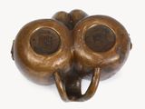 a bronze sculpture of an elephant head with two eyes