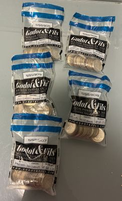 four bags of cookies are sitting on a counter top