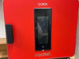 the microwave oven is red and has a digital screen on top of it