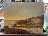 une photo d'un tableau représentant une scène de plage, posé sur un chevalet