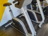 a row of stationary exercise bikes in a gym