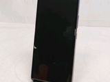 the back of a black cell phone sitting on top of a table