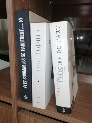 two books that are sitting on a book shelf