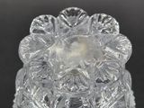 a close up of a clear glass candle holder on a black surface