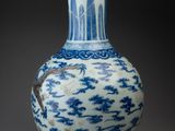 a blue and white vase sitting on a table