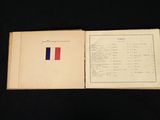 an open book with a red, white, and blue flag on it