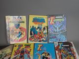 a lot of comic books sitting on a table