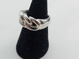 a close up of a silver ring on a black cone