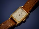 an image of a gold watch with a brown leather strap