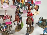 many figurines of soldiers on display in a display case