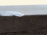 a close up of a cement block with a hole in it