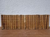 a stack of old books sitting on top of a wooden table