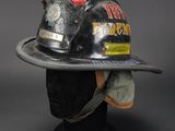 fireman ' s helmet on a mannequin head with a hat on it