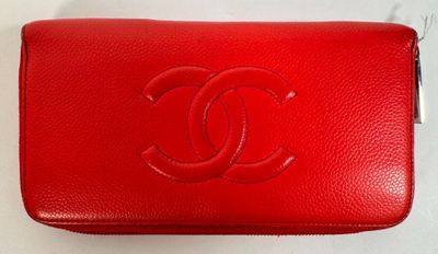 a red chanel purse on a white surface