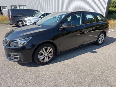 the black car is parked in the parking lot next to other cars