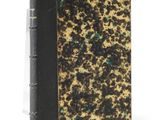an old book with a black cover and gold speckles on it