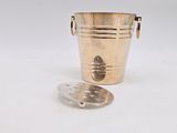 a gold bucket with a spoon in it and a spoon in it