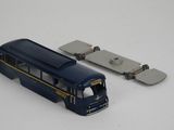 a toy bus that is sitting next to a skateboard
