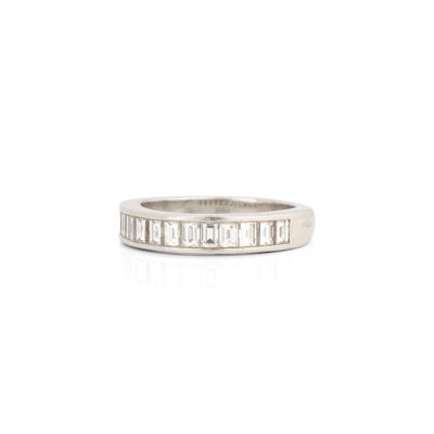 un gros plan sur une bague en or blanc sertie de diamants taille baguette