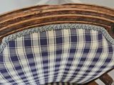a chair with a blue and white checkered cushion on it