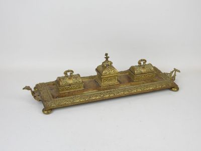 an antique brass inkwell with three inkwells on top of it