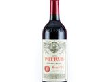 une bouteille de vin rouge posée sur une table blanche