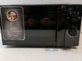 a black microwave oven sitting on a counter top
